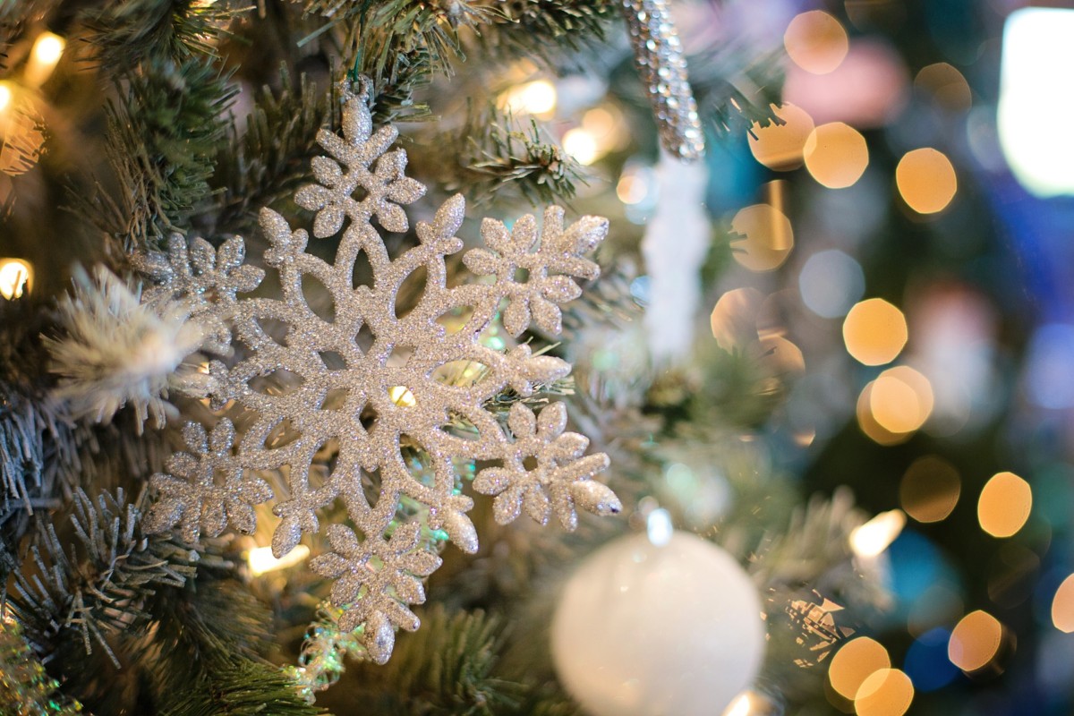A snowflake ornament on a Christmas tree.